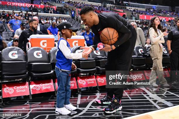 Russell Westbrook of the LA Clippers high fives a fan prior to the game against the Orlando Magic on March 18, 2023 at Crypto.Com Arena in Los...