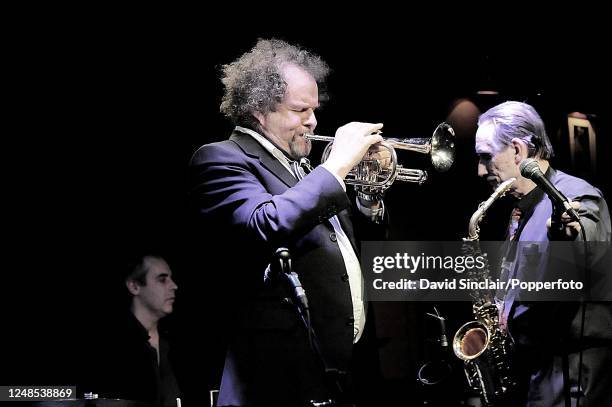 English film director and musician Mike Figgis performs live on stage playing a trumpet at Ronnie Scott's Jazz Club in Soho, London on 3rd February...