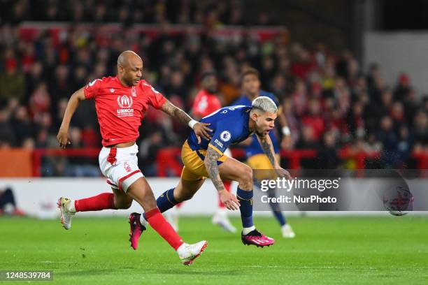 Andr Ayew of Nottingham Forest battles with Bruno Guimaraes of Newcastle United during the Premier League match between Nottingham Forest and...