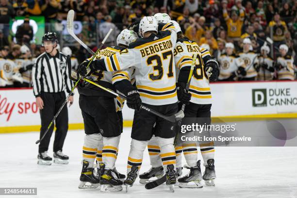 Boston Bruins right wing David Pastrnak celebrates with teammates after a goal during the NHL game between the Boston Bruins and Minnesota Wild, on...