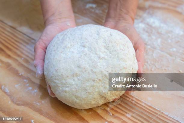 woman hands holding pizza dough - pizza crust stock pictures, royalty-free photos & images