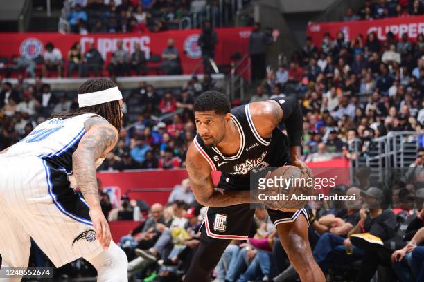 Paul George of the LA Clippers handles the ball during the game against the Orlando Magic on March 18, 2023 at Crypto.Com Arena in Los Angeles,...