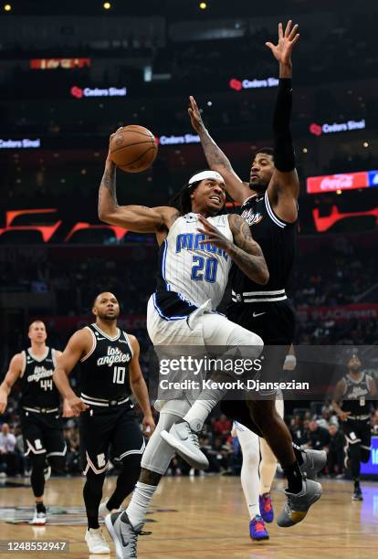 Markelle Fultz of the Orlando Magic drives to the basket against Paul George of the Los Angeles Clippers during the first half at Crypto.com Arena on...