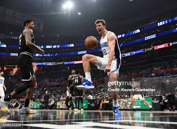Franz Wagner of the Orlando Magic scores a basket against Paul George of the Los Angeles Clippers during the first half at Crypto.com Arena on March...