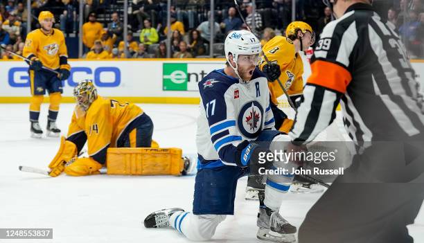 Adam Lowry of the Winnipeg Jets celebrates his goal against the Nashville Predators during an NHL game at Bridgestone Arena on March 18, 2023 in...