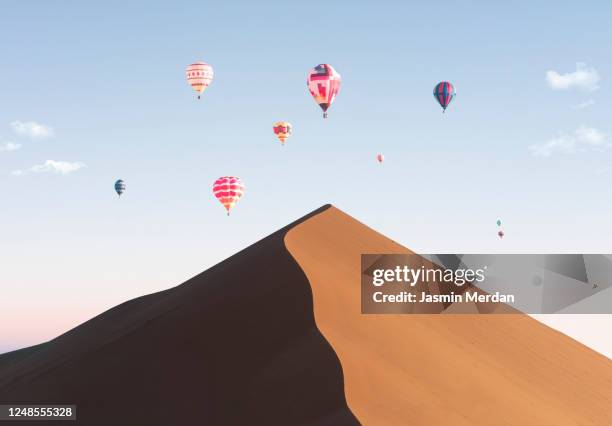 colorful hot air balloon over desert at sunset - sahara　sunrise ストックフォトと画像