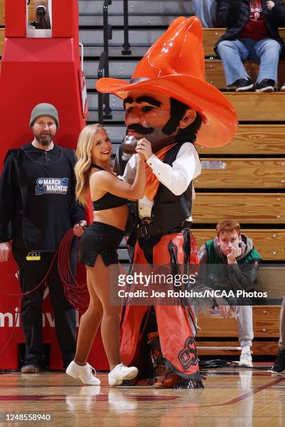 Oklahoma State Cowgirls mascot dances with a cheerleader in a game against the Miami Hurricanes during the first round of the 2023 NCAA Women's...