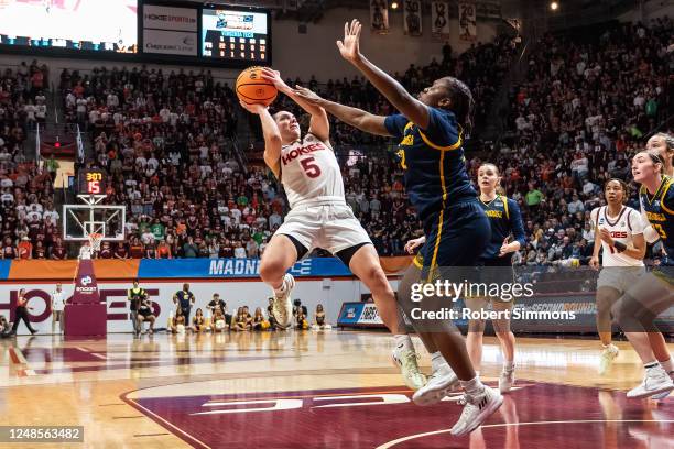 Georgia Amoore of the Virginia Tech Hokies drives by Raven Thompson of the Chatanooga MOCs during the first round of the 2023 NCAA Women's Basketball...