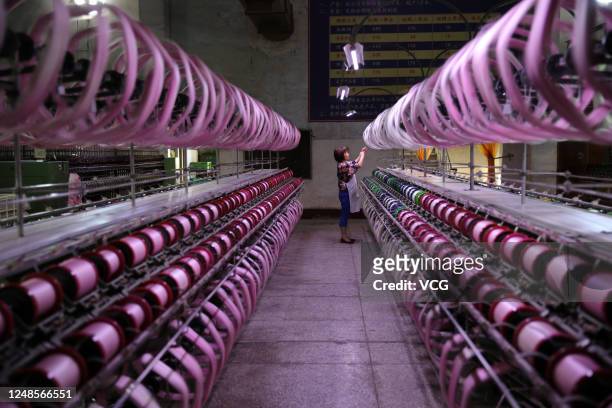 An employee works at a workshop of a silk textile factory on June 9, 2020 in Neijiang, Sichuan Province of China.
