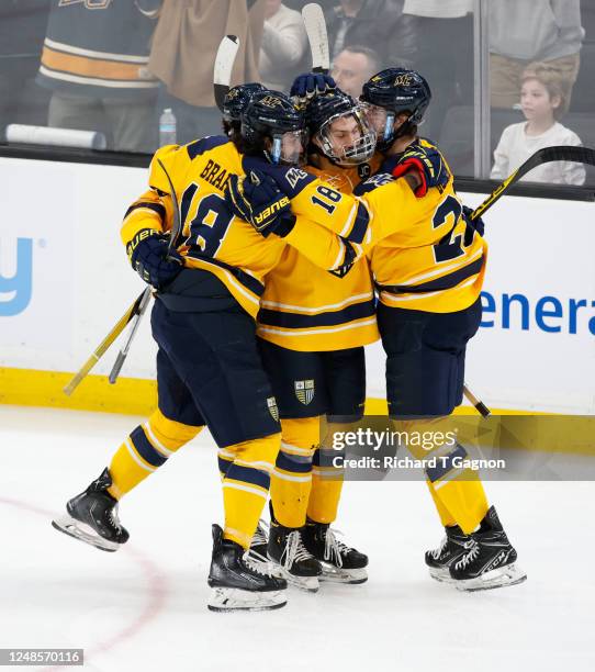 Christian Felton of the Merrimack Warriors celebrates with teammates Will Calverley, Ben Brar and Slava Demin after he scores against the Boston...
