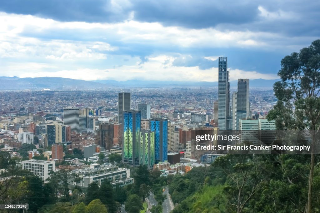 Bogota skyline with colorful skyscrapers at dusk with dramatic sky in Colombia