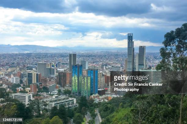 bogota skyline with colorful skyscrapers at dusk with dramatic sky in colombia - bogota stock pictures, royalty-free photos & images