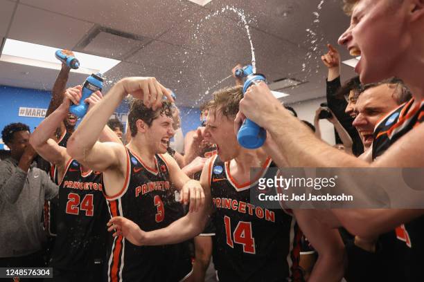 Princeton Tigers players celebrate in the locker room after a win against the Missouri Tigers during the second round of the 2023 NCAA Men's...