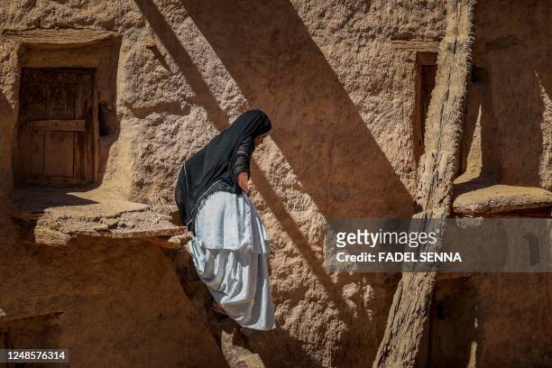 Woman walks at the ancient collective granary of Ait Kine village in Morocco's region of Tata on March 1, 2023. - High in the rugged hills some 460...