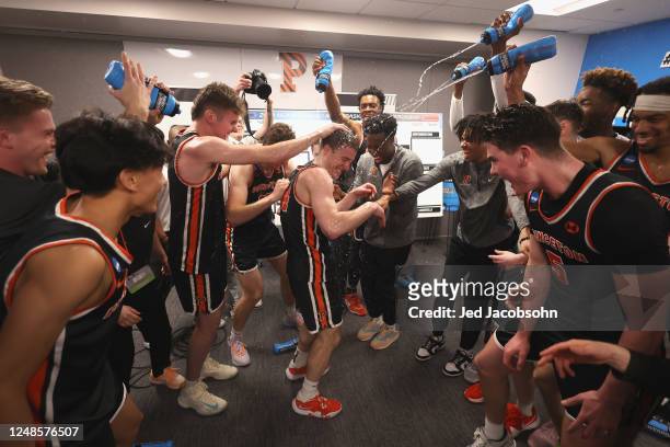 Princeton Tigers players celebrate in the locker room after a win against the Missouri Tigers during the second round of the 2023 NCAA Men's...