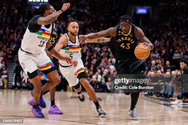 Pascal Siakam of the Toronto Raptors drives to the net against Naz Reid and Kyle Anderson of the Minnesota Timberwolves during the second half of...