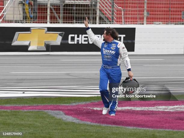 Josh Williams waves to the crowd after leaving his car on the front stretch during the NASCAR Xfinity Series RAPTOR King of Tough 250 on March 18 at...