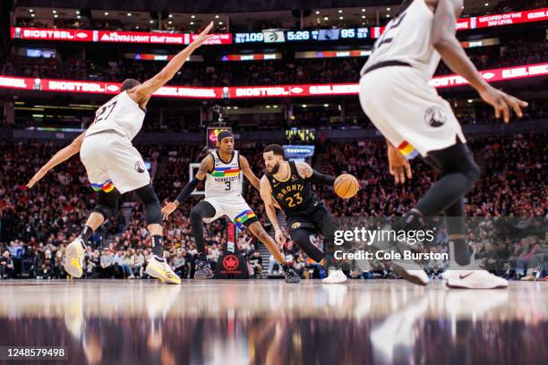 Fred VanVleet of the Toronto Raptors drives to the net against Jaden McDaniels and Rudy Gobert of the Minnesota Timberwolves during second half of...