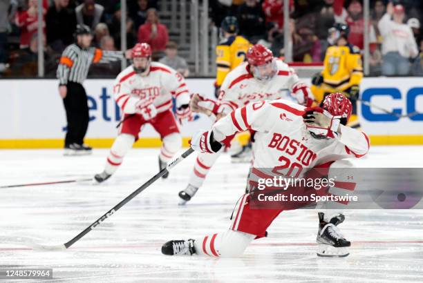Boston University Terriers defenseman Lane Hutson celebrates his tournament winner in overtime to win the Hockey East Championship game between the...