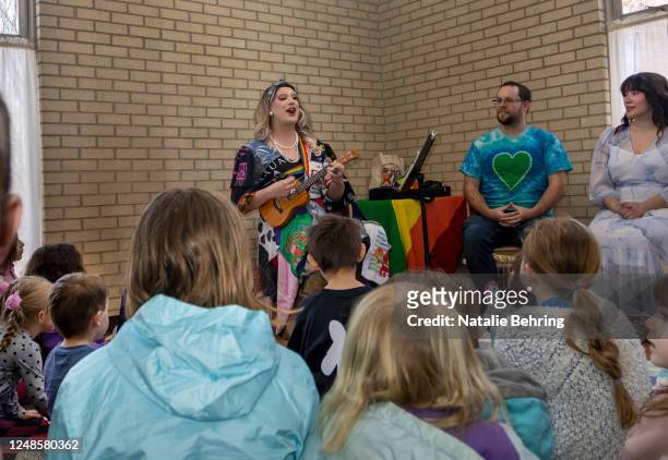 Drag queen Cali Je plays a ukulele and sings to a group of children at a reading event on March 18, 2023 in Pocatello, Idaho. Idaho is one of many...
