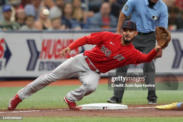 Boston Red Sox third baseman Matthew Lugo reaches to make a catch a throw from the catcher during the MLB spring training game between the Boston Red...