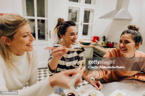 girls having dinner together at home - chopsticks stock pictures, royalty-free photos & images