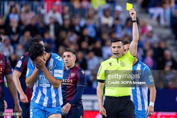 Referee Oliver de la Fuente Ramos seen showing yellow card to Juande Rivas during the LaLiga Smartbank match between Malaga CF and Levante UD at La...