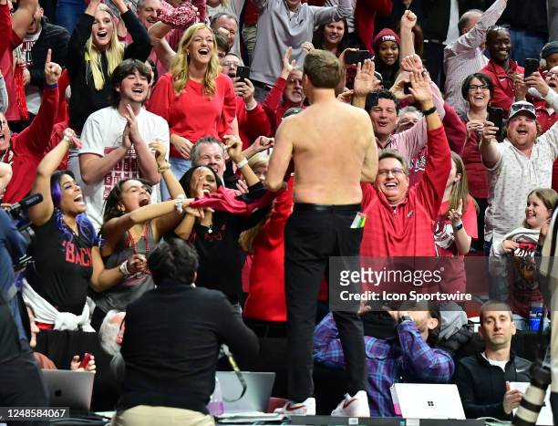 Arkansas Razorbacks coach Eric Musselman removes his shirt and greets the Arkansas fans after upsetting Kansas during the second round of the NCAA...