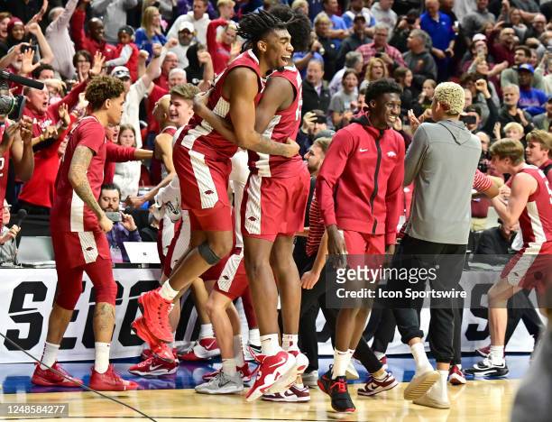 Arkansas players react after upsetting Kansas during the second round of the NCAA Division 1 Men's Basketball Championship West Regional between the...