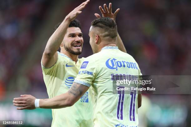 Jonathan Rodríguez of America celebrates with teammate after scoring the team's second goal during the 12th round match between Chivas and America as...