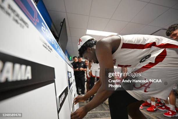 Charles Bediako of the Alabama Crimson Tide moves Alabamas name plate to the Sweet Sixteen after win against the Maryland Terrapins during the second...