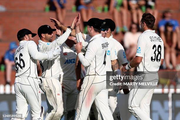 New Zealand players celebrate Sri Lanka's captain Dimuth Karunaratne being caught on day three of the second Test cricket match between New Zealand...