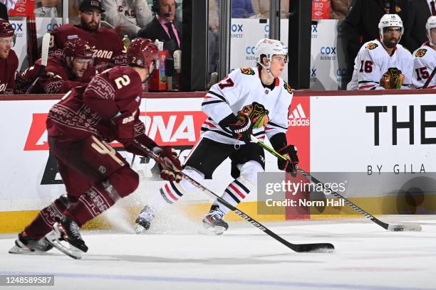 Lukas Reichel of the Chicago Blackhawks skates with the puck during the third period against the Arizona Coyotes at Mullett Arena on March 18, 2023...