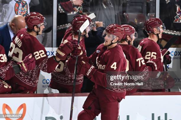 Juuso Valimaki of the Arizona Coyotes celebrates with teammates on the bench after scoring a goal against the Chicago Blackhawks during the third...