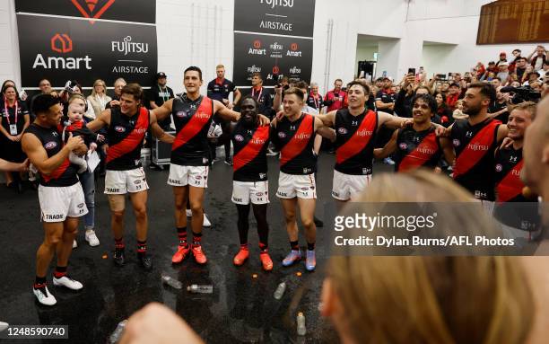 Essendon sing the team song during the 2023 AFL Round 01 match between the Hawthorn Hawks and the Essendon Bombers at the Melbourne Cricket Ground on...