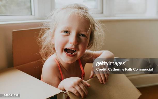 cute girl in a cardboard box - playhouse stock pictures, royalty-free photos & images