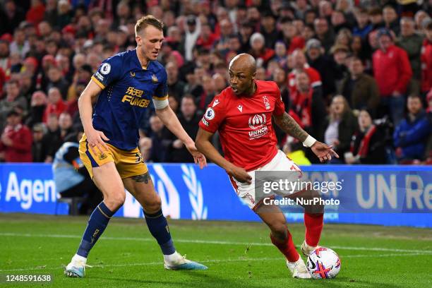 Andr Ayew of Nottingham Forest looking for options under pressure from Dan Burn of Newcastle United during the Premier League match between...