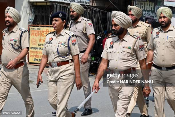 Punjab Police personnel patrol in a village near Jallupur Khera about 45 km from Amritsar on March 19, 2023. - A manhunt for a radical Sikh preacher...