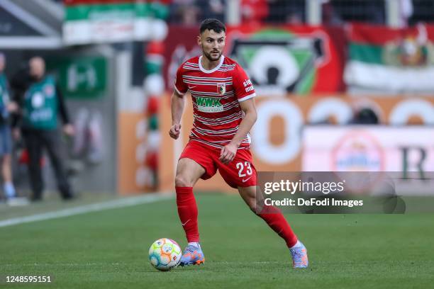 Maximilian Bauer of FC Augsburg controls the ball during the Bundesliga match between FC Augsburg and FC Schalke 04 at WWK-Arena on March 18, 2023 in...