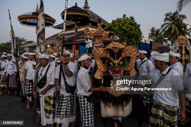 Balinese Hindus people carry the sacred Barong, the lion-like creature and character in the mythology of Bali as a symbol of health and good fortune,...