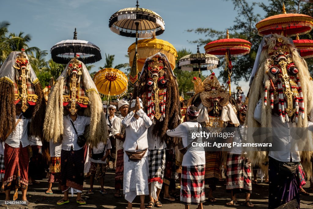 Balinese Ritual Object Balinese Hindus people carry sacred mask, sacred effigies and ritual ...