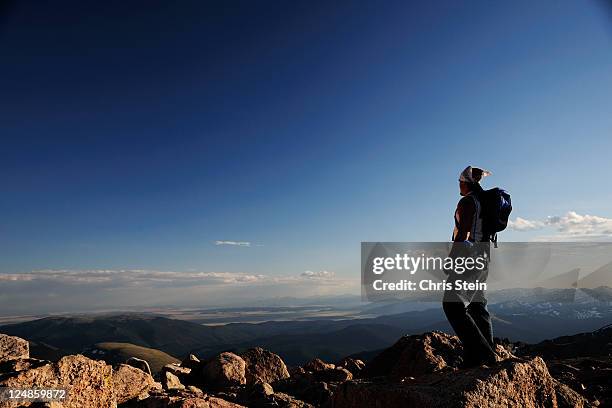 man stands alone on top of a mountain - denver co stock pictures, royalty-free photos & images