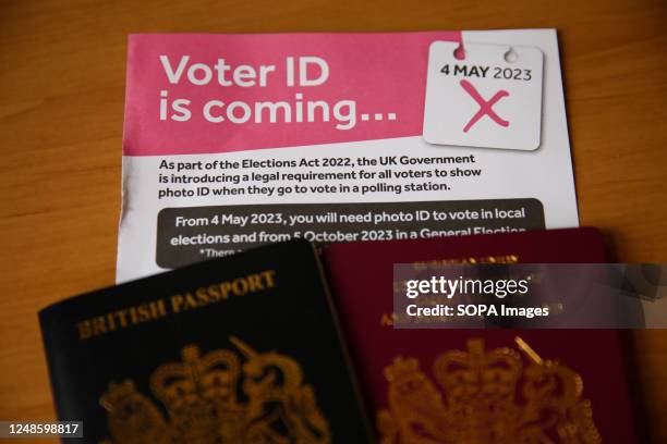 In this photo illustration, British passports with a leaflet showing that voters in England will need to show a photo ID to vote at polling stations...