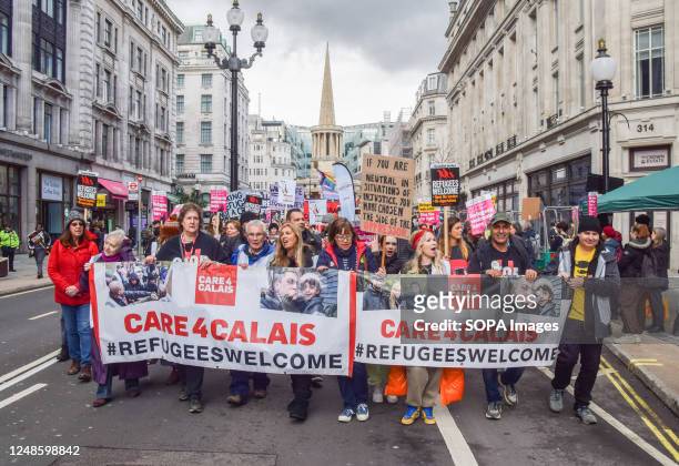 Protesters march with Care 4 Calais banners during the demonstration in Regent Street. Thousands of people marched through Central London in support...