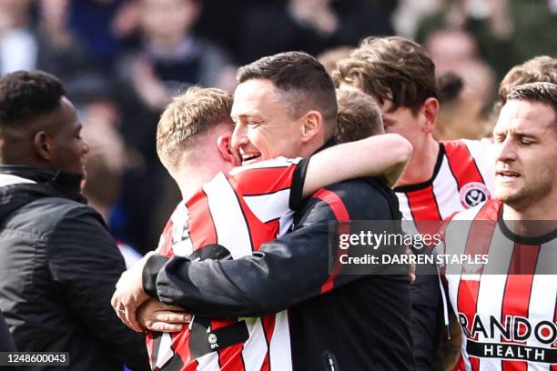 Sheffield United's English midfielder Tommy Doyle celebrates with Sheffield United's manager Paul Heckingbottom at the end of the English FA Cup...