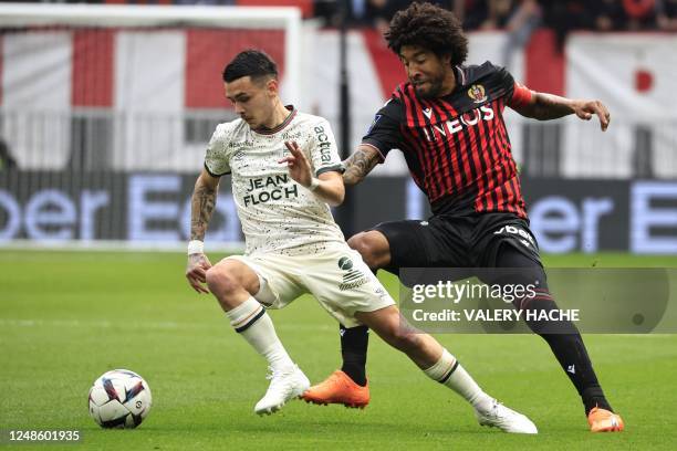 Lorient's French midfielder Enzo Le Fee fights for the ball with Nice's Brazilian defender Dante during the French L1 football match between OGC Nice...