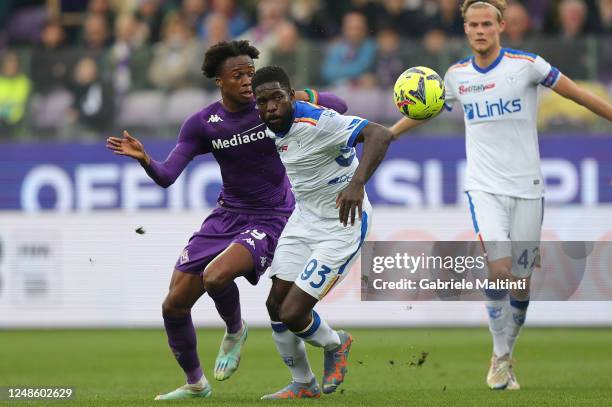 Christian Michael Kouakou Kouamé of ACF Fiorentina battles for the ball with Samuel Yves Umtiti of US Lecce during the Serie A match between ACF...