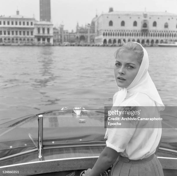 Italian actress Virna Lisi driving a water taxi, venice, 1959.