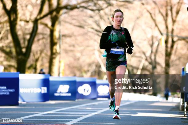Karoline Bjerkeli Grovel of Norway crosses the finish line to finish third in the Womens United Airlines NYC Half Marathon on March 19, 2023 in New...