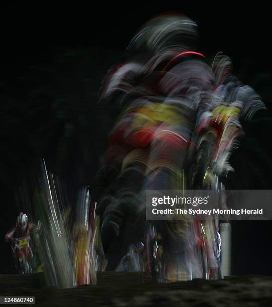 Blur of motion as competitors navigate the undulating terrain during competition at the Supercross Masters Grand Final held at a packed Central Coast...